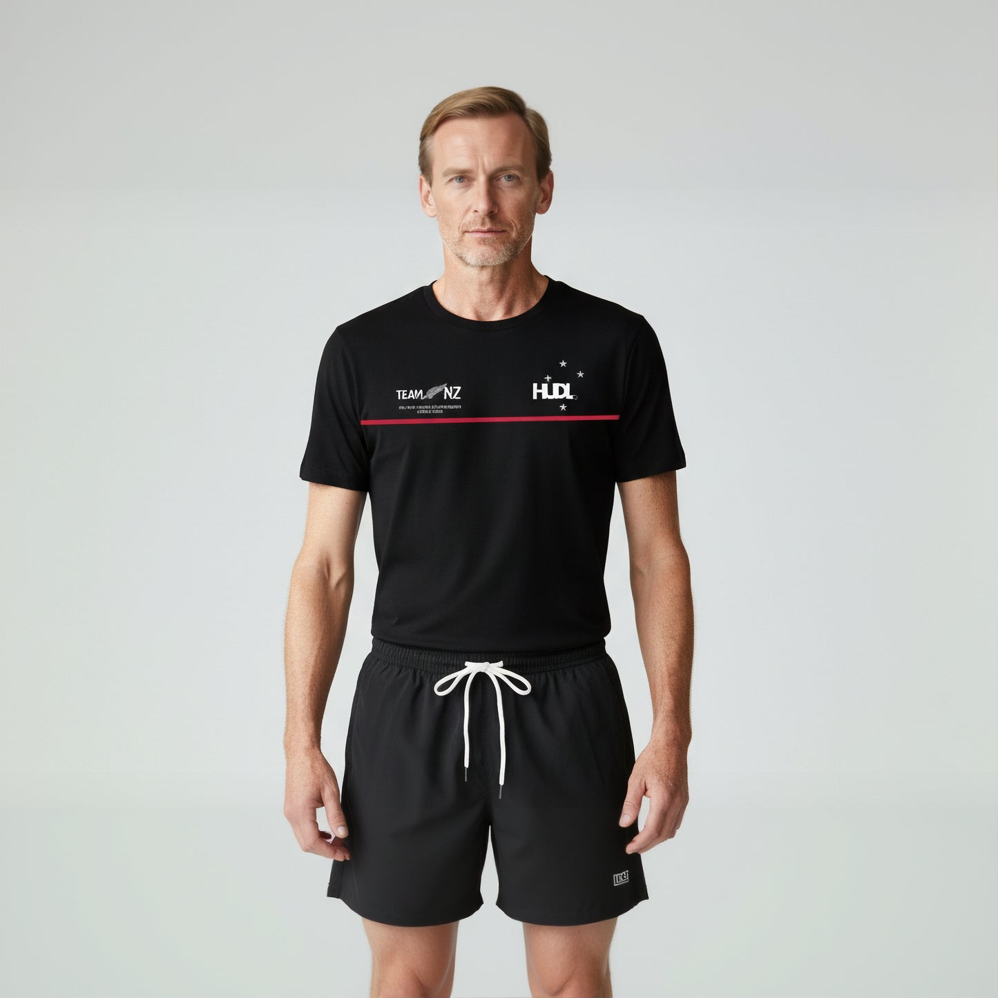 Man wearing Paul Coll 2026 team support squash shirt pre-sale – back NZ's finest on court with HUDL Athletica.  
