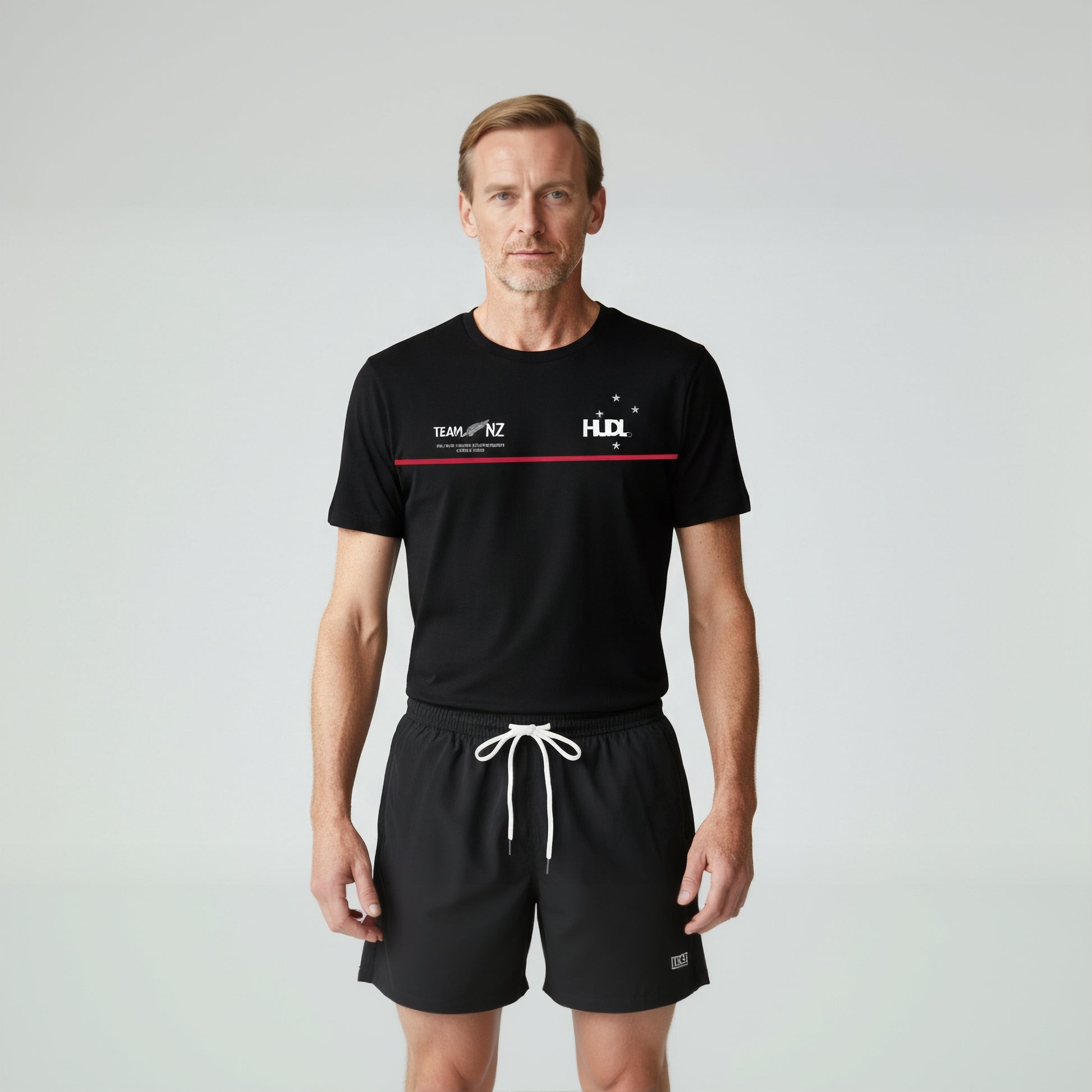 Man wearing Paul Coll 2026 team support squash shirt pre-sale – back NZ's finest on court with HUDL Athletica.  