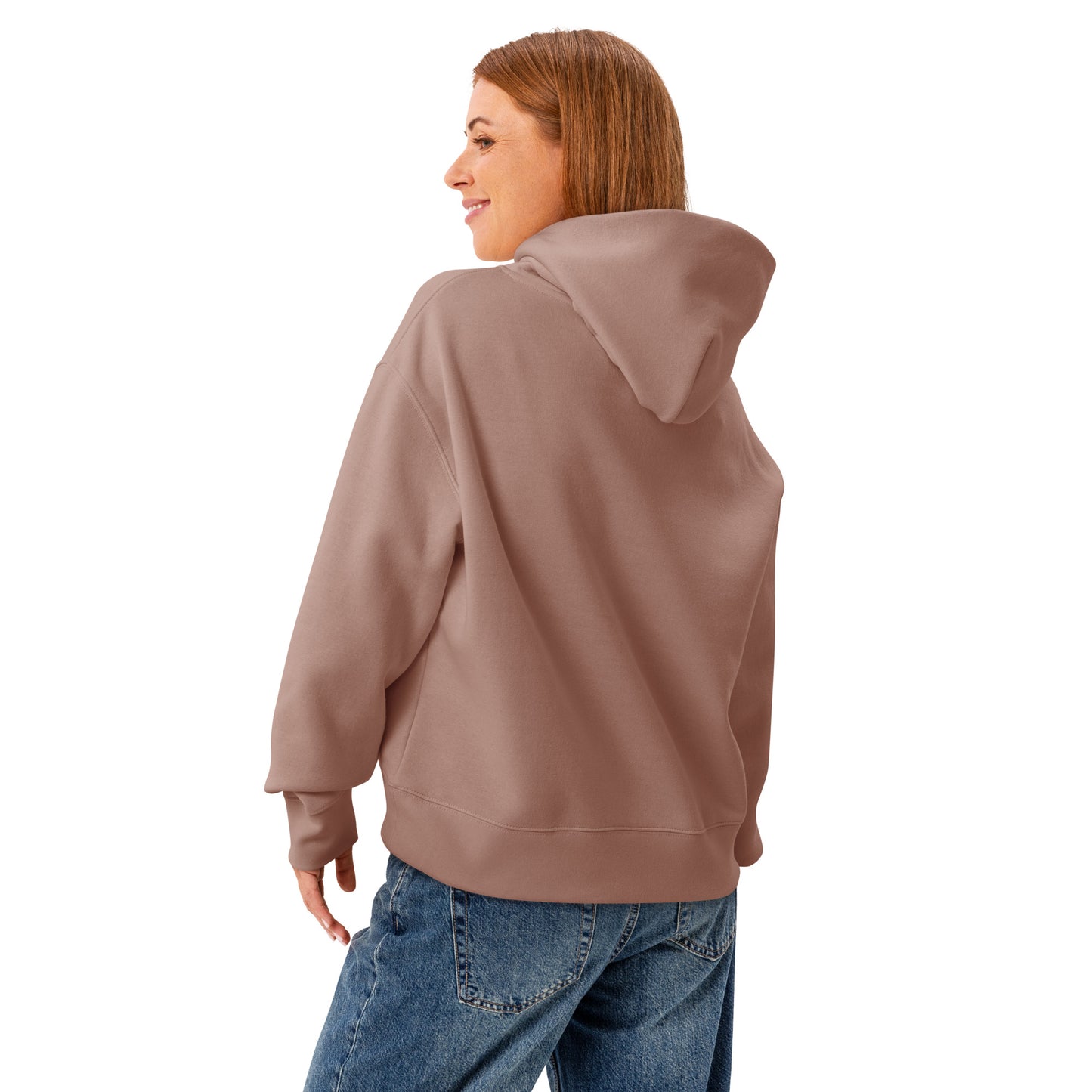 A woman standing wearing a HUDL women's relaxed fit pullover hoodie – off-court squash style, embroidered logo in hazy pink