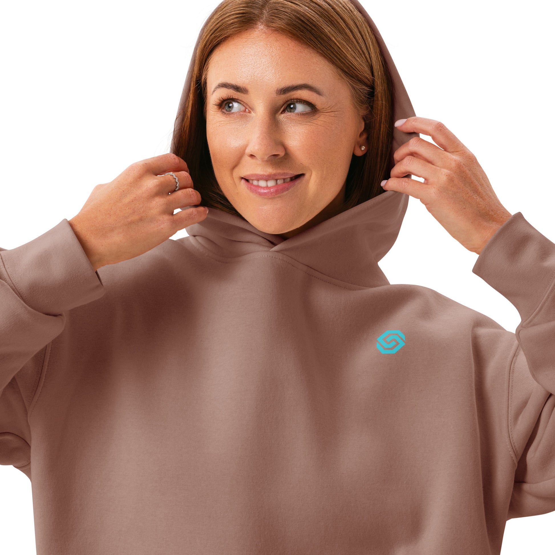 A close up of a woman standing wearing a HUDL women's relaxed fit pullover hoodie – off-court squash style, embroidered logo in hazy pink