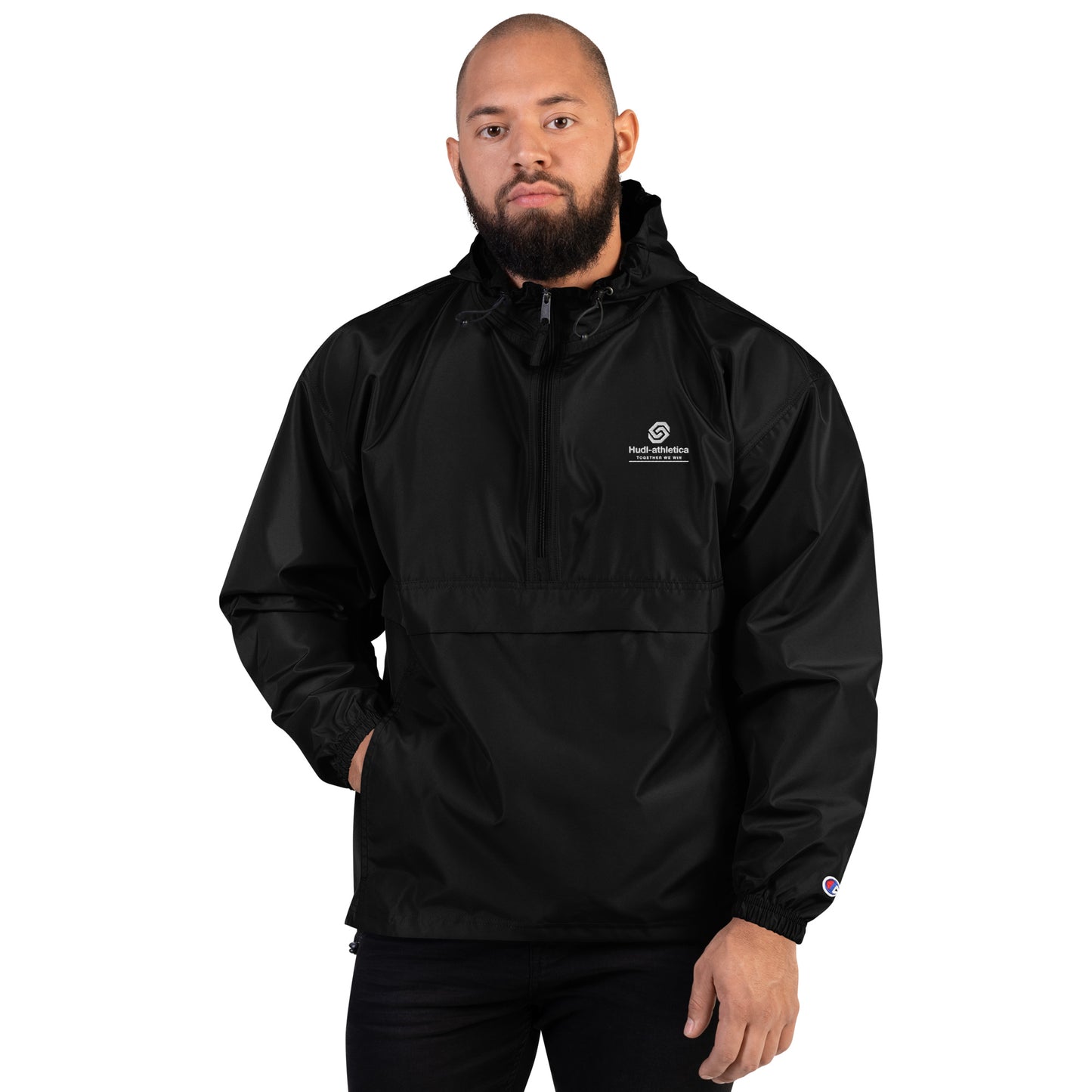 A man wearing the HUDL lightweight packable windbreaker jacket – squash warm-up gear, embroidered logo in black