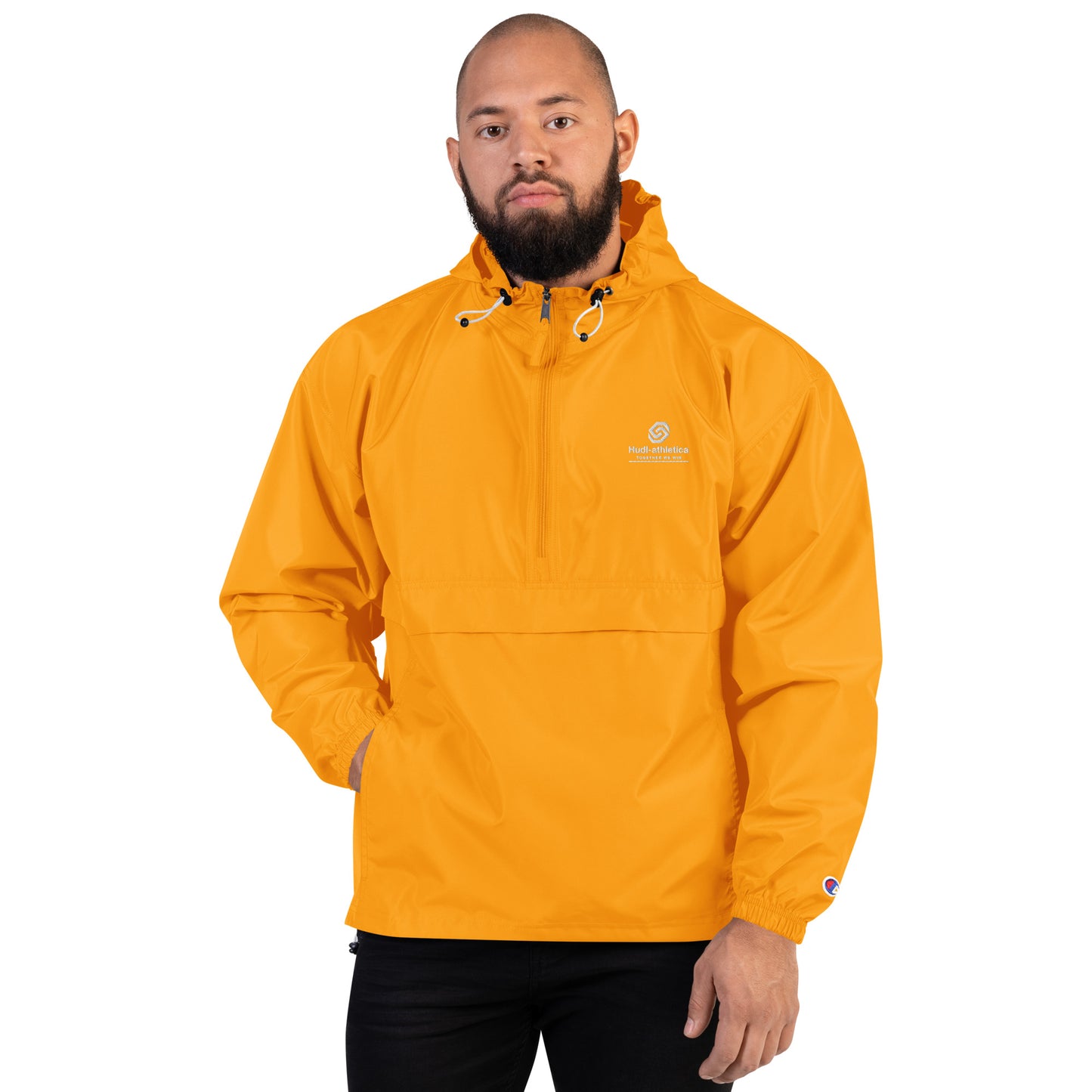 A man wearing the HUDL lightweight packable windbreaker jacket – squash warm-up gear, embroidered logo in yellow