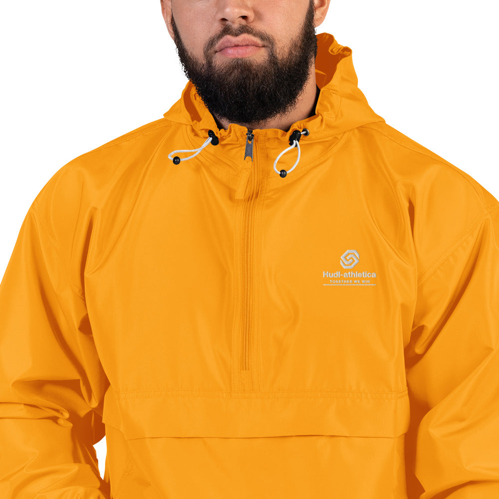 A close up of a man wearing the HUDL lightweight packable windbreaker jacket – squash warm-up gear, embroidered logo in yellow