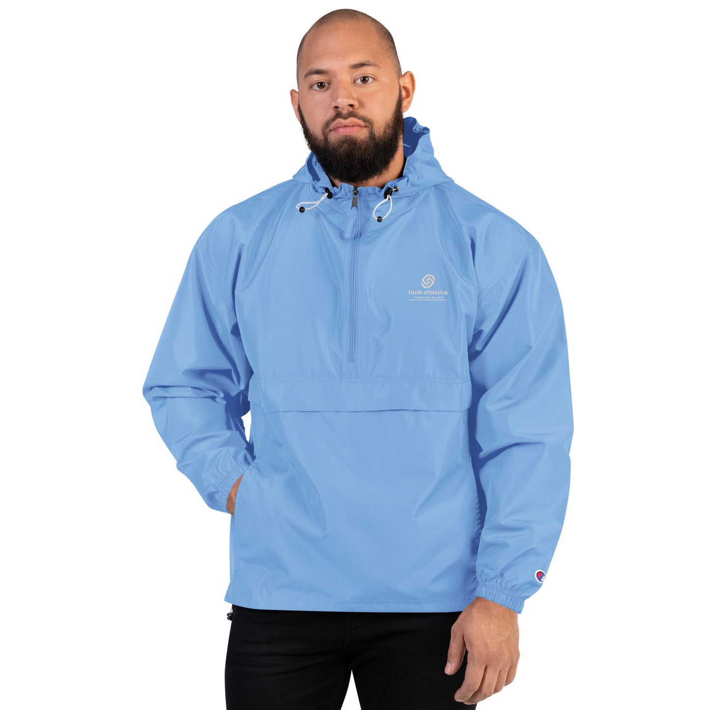 A man wearing the HUDL lightweight packable windbreaker jacket – squash warm-up gear, embroidered logo in light blue