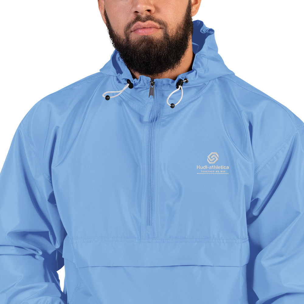 A close up of a man wearing the HUDL lightweight packable windbreaker jacket – squash warm-up gear, embroidered logo in light blue