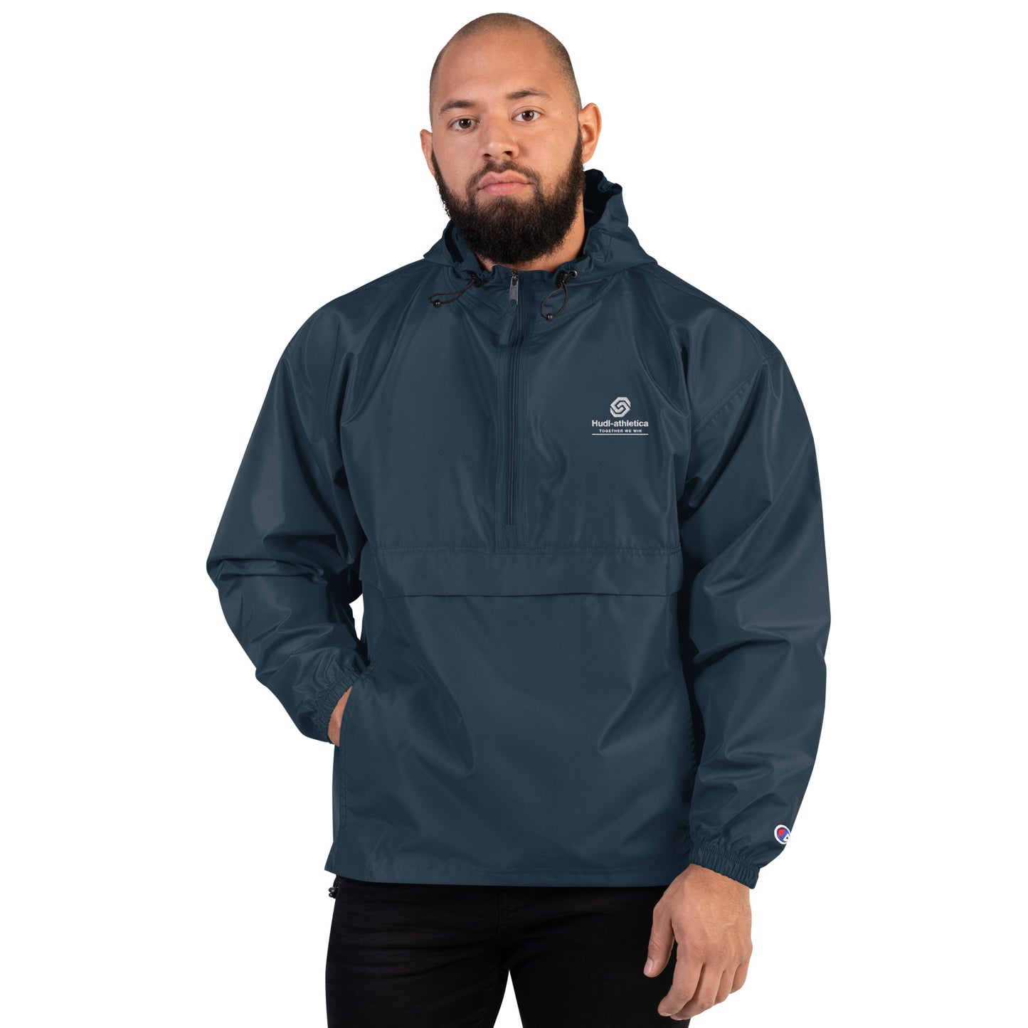 A man wearing the HUDL lightweight packable windbreaker jacket – squash warm-up gear, embroidered logo in navy