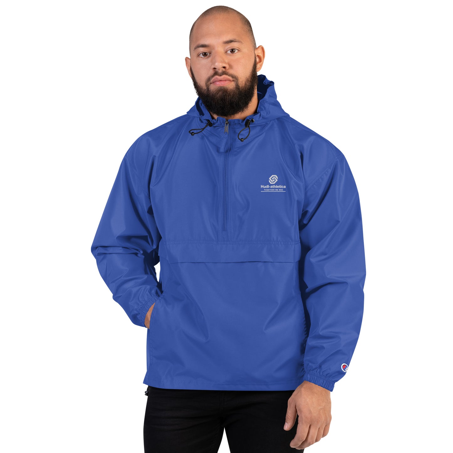 A man wearing the HUDL lightweight packable windbreaker jacket – squash warm-up gear, embroidered logo in royal