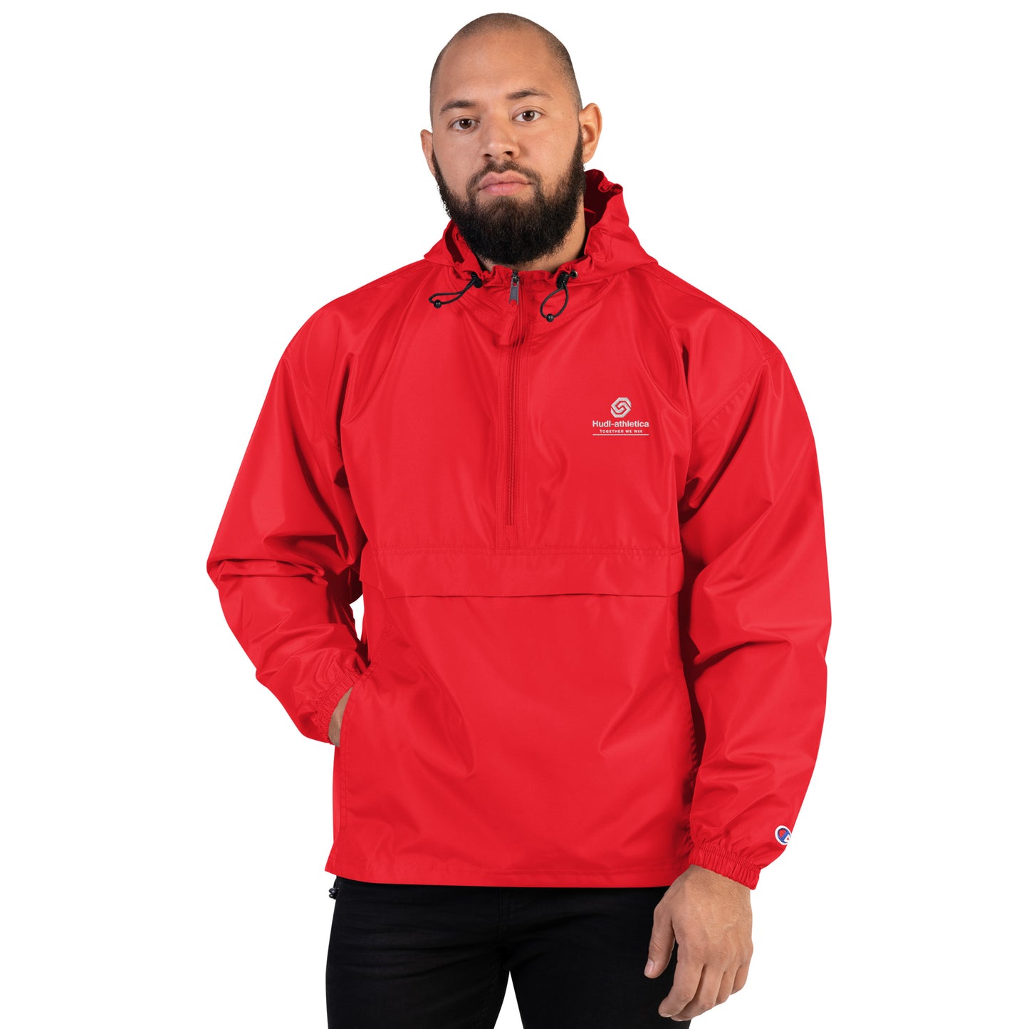 A  man wearing the HUDL lightweight packable windbreaker jacket – squash warm-up gear, embroidered logo in red