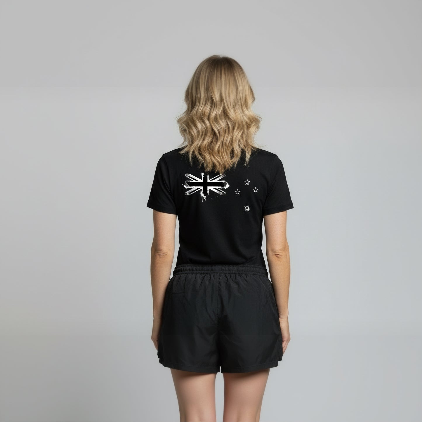 Back view of a women wearing Paul Coll 2026 team support squash shirt pre-sale – back NZ's finest on court with HUDL Athletica.  