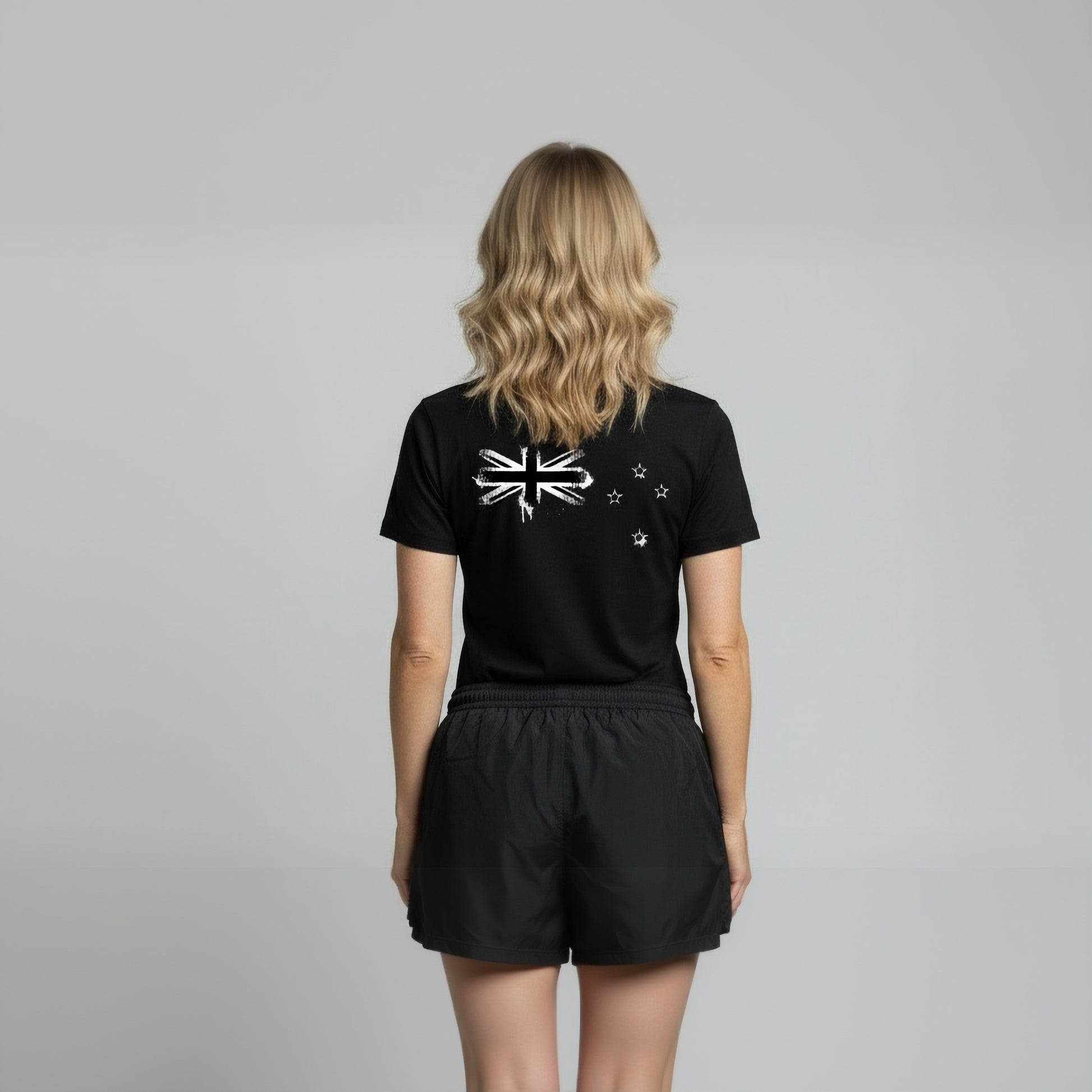 Back view of a women wearing Paul Coll 2026 team support squash shirt pre-sale – back NZ's finest on court with HUDL Athletica.  