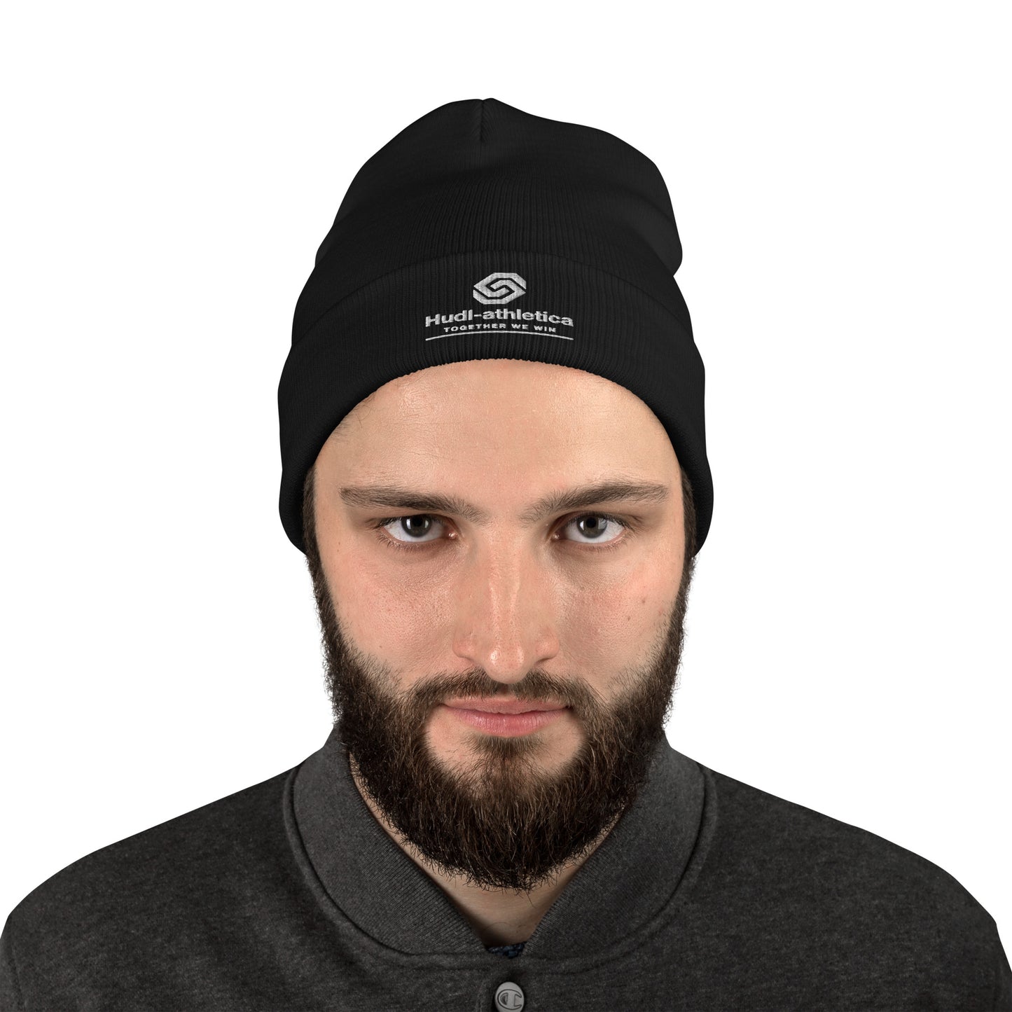 A close up of a man wearing a HUDL embroidered knit beanie – squash community streetwear, warm and stylish off-court in Black