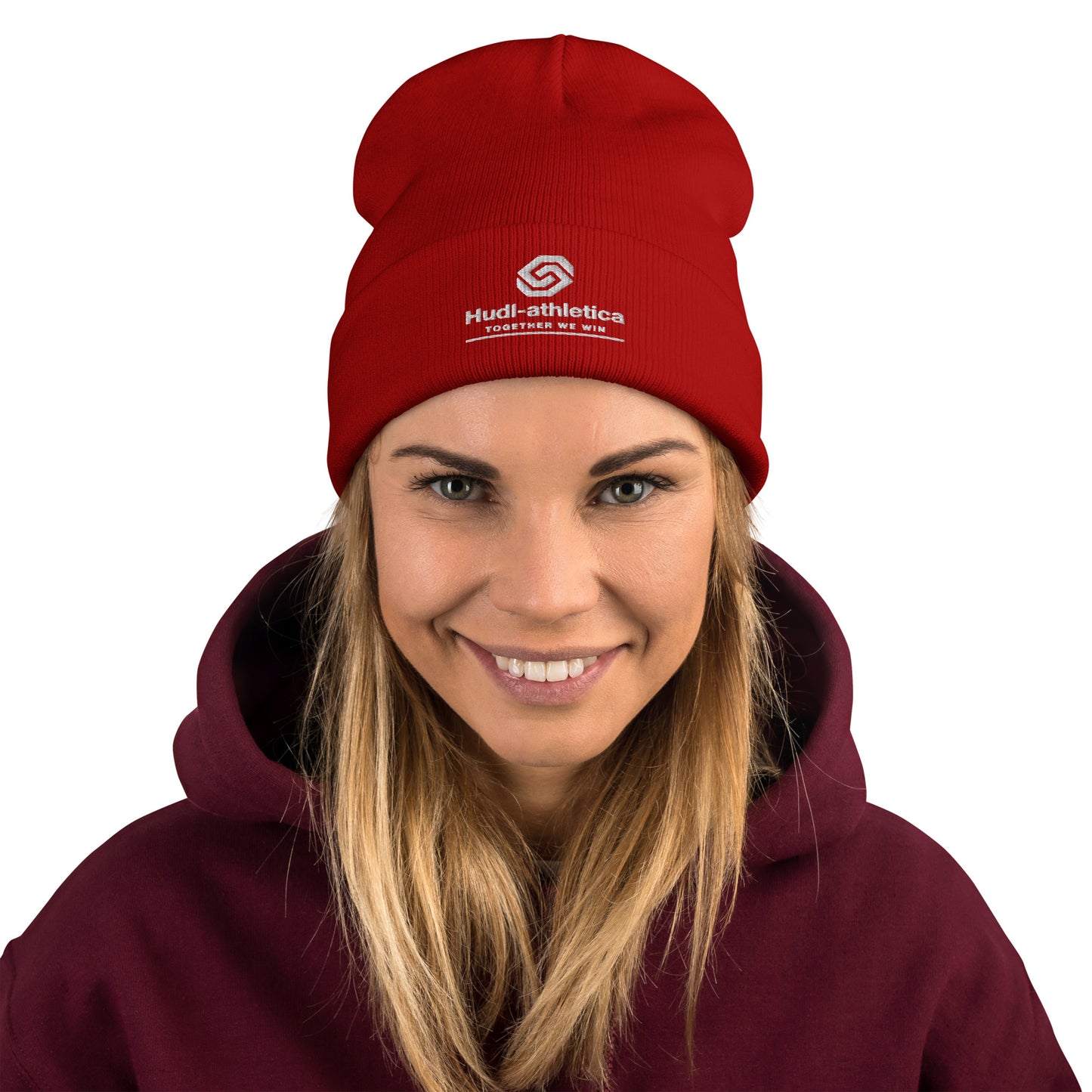 A closeup of a woman wearing a HUDL embroidered knit beanie – squash community streetwear, warm and stylish off-court in red