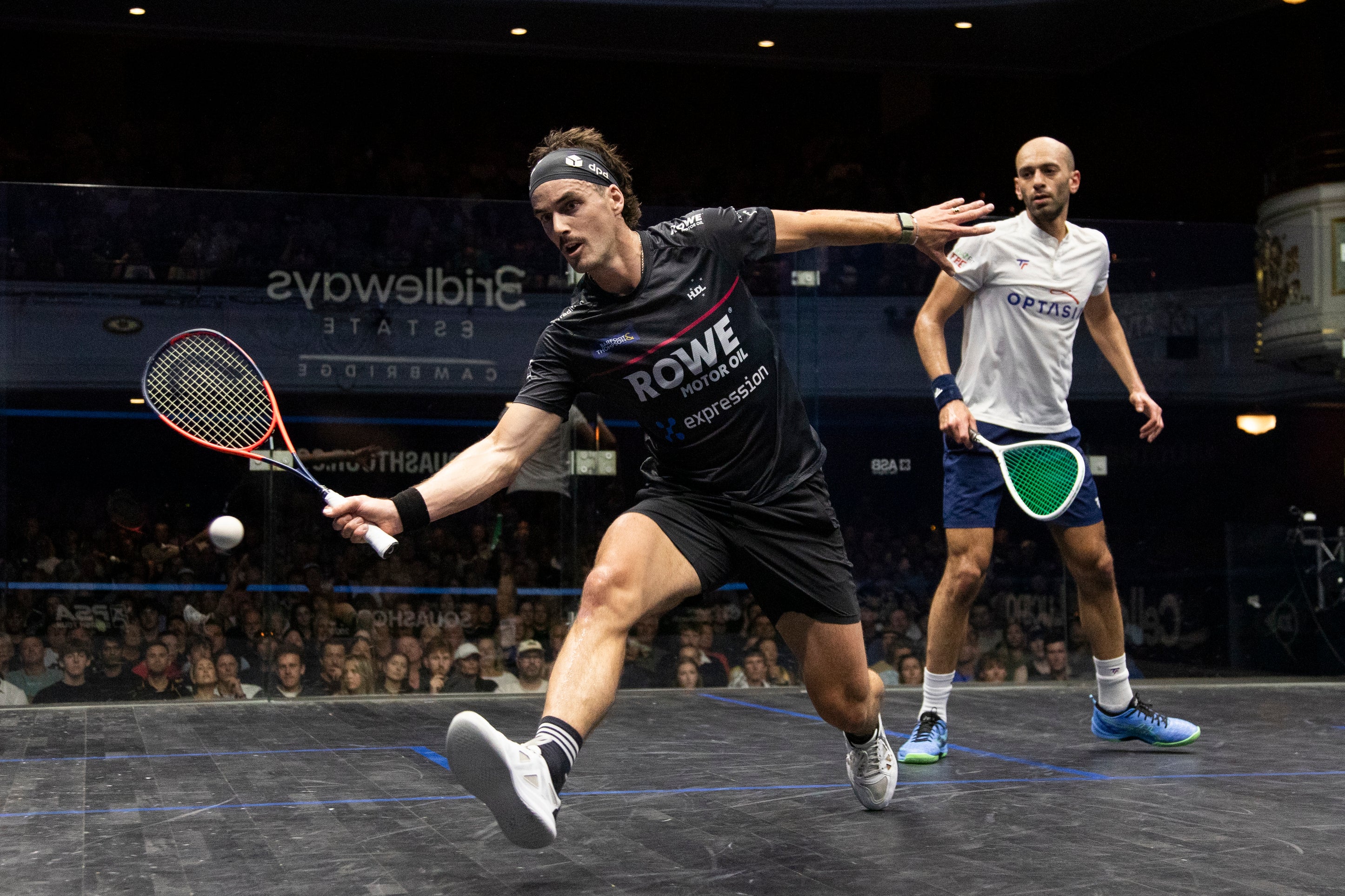Paul playing in the Paul Coll Tournament squash shirt" and "XTPro performance apparel against Marwan El Shorbagy