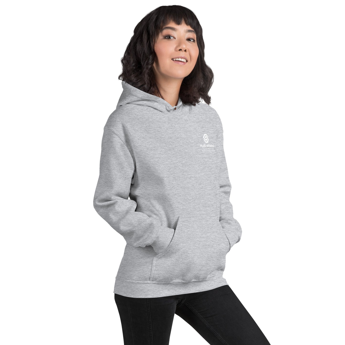 A woman wearing a HUDL unisex pullover fleece hoodie – squash off-court essential, embroidered HUDL logo in light grey heather 